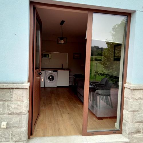 a sliding glass door leading to a living room and kitchen at Casa Mariví in Niembro