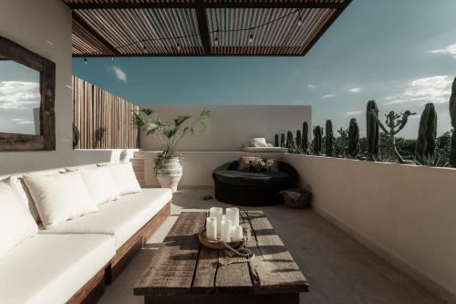 a living room with a white couch and a table at Ka'ana Condo in Tulum