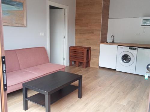 a living room with a couch and a washing machine at Casa Mariví in Niembro