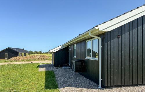 a black building with a window on the side of it at Lovely Home In Stege With Sauna in Stege