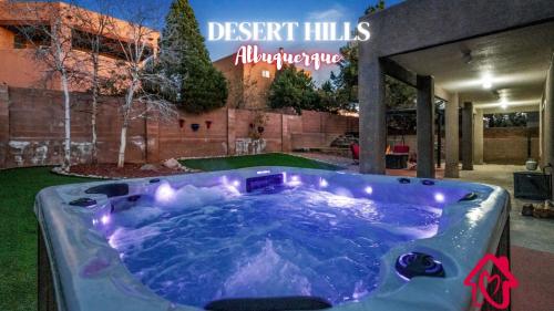 a jacuzzi tub in the yard of a house at Desert Hills - An Irvie Home in Albuquerque