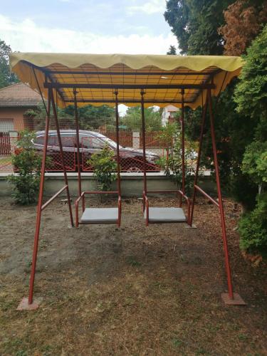 a gazebo with two potted plants in it at Villa Negra 1 in Balatonfenyves
