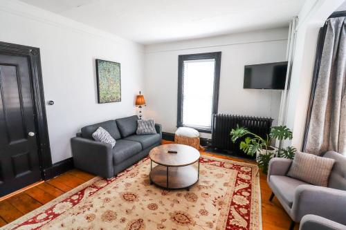 a living room with a couch and a table at Centrally located East End & off-street parking in Portland