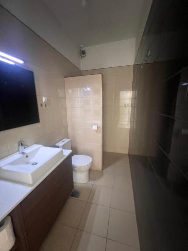 a bathroom with a sink and a toilet at Sea View Apartments in Herceg-Novi