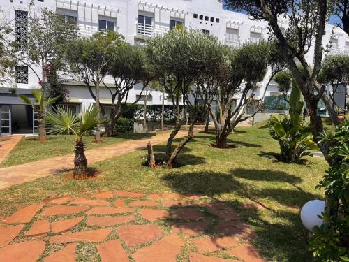 a park with trees and a building in the background at Luxury Sea View in Tamaris