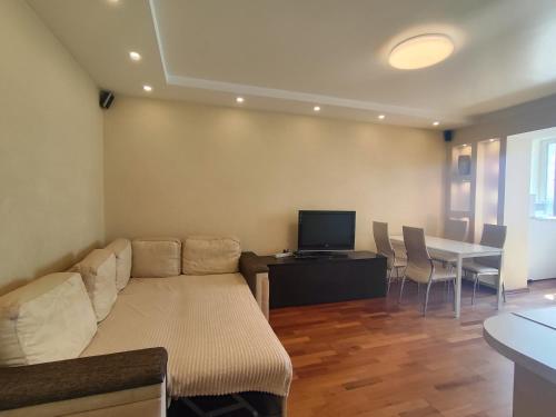 a living room with a couch and a table at 1/10 вулиця Радунська in Kyiv