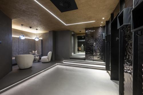 a bathroom with a tub in the middle of a room at Hotel Kendler in Saalbach Hinterglemm
