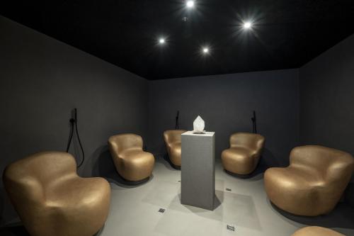 a room with brown chairs and a table and lights at Hotel Kendler in Saalbach Hinterglemm