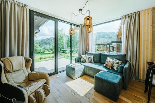 a living room with a couch and a chair at Yama Krywe in Krywe