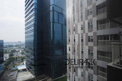 a view of a tall skyscraper in a city at Delipark Mall 2 Bedrooms 2 Bathrooms 4-6 Pax Lexington Tower Level 11 in Medan