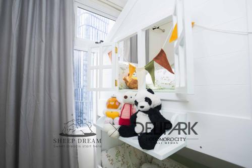 a shelf with stuffed animals in a room at Delipark Mall 2 Bedrooms 2 Bathrooms 4-6 Pax Lexington Tower Level 11 in Medan