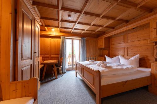 a bedroom with a bed in a wooden room at Ferienwohnungen Chiemgau in Rottau