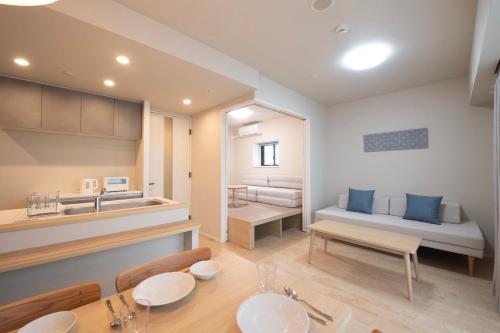 a kitchen and living room with a table and a couch at THE RISE Osaka Universal Bayside in Osaka