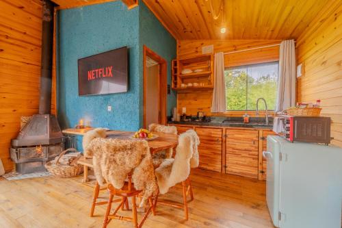 a kitchen and dining room with a table and a stove at Cascata dos Amores in Urubici