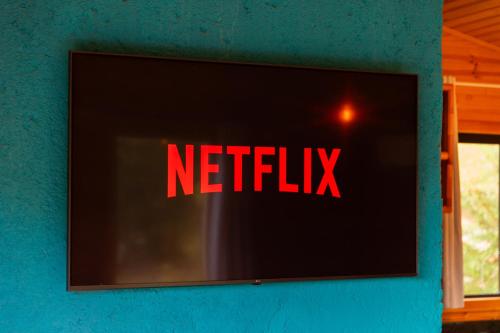 a netflix sign on the side of a wall at Cascata dos Amores in Urubici