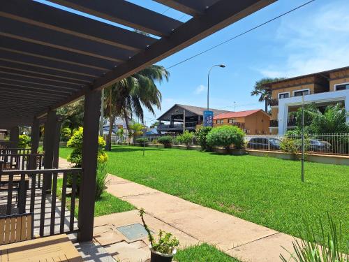 a view of a park with grass and buildings at Kololi Beach Resort in Kololi