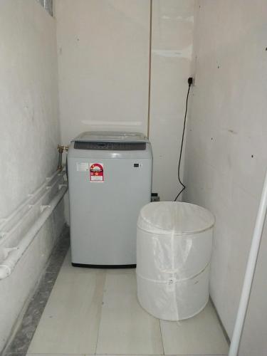 a small refrigerator in a room with a trash can at Tropical villa Pereybere in Pereybere