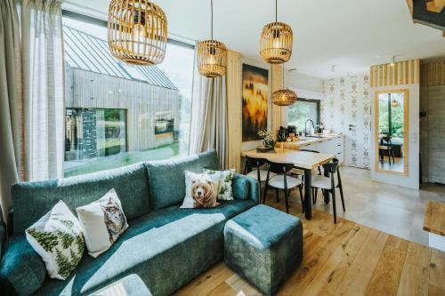 a living room with a blue couch and a table at Yama Krywe in Krywe