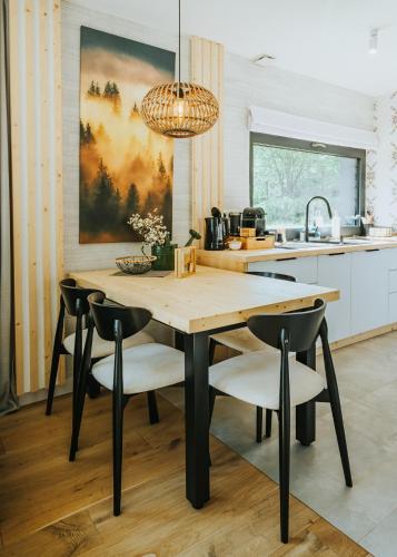a kitchen with a wooden table and chairs at Yama Krywe in Krywe