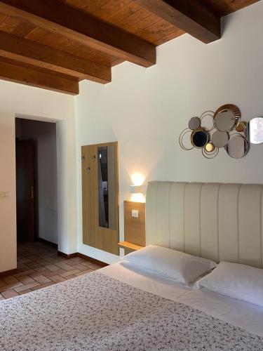 a bedroom with a large bed and a ceiling at Agriturismo La Rondinella in Dozza