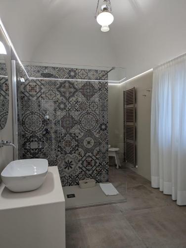 a bathroom with a toilet and a sink and a shower at Al Corso Charming Rooms in Peschici