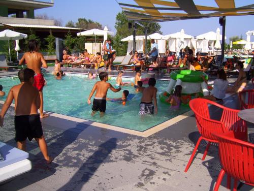 a group of children playing in a swimming pool at Verginia Studios in Korinós