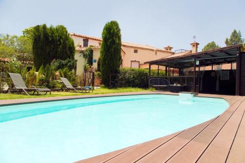 a swimming pool in front of a house at Hotel Rural El Refugio in Tejeda