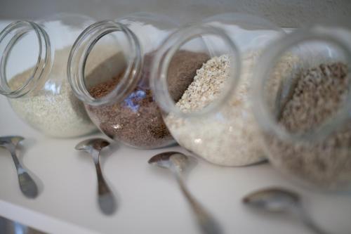 four glass containers filled with grains and spoons at Hotel Restaurant Am Kellhof in Singen