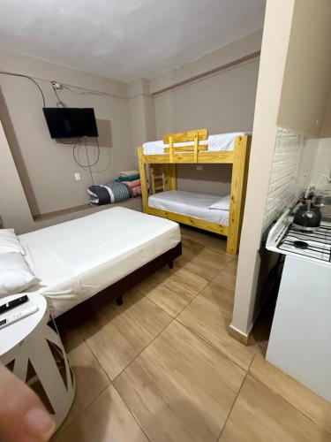 a small room with two bunk beds in it at Departamento Bita in Puerto Iguazú