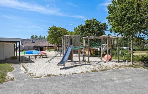 a playground with a slide in the sand at Amazing Home In Tarm With Kitchen in Tarm