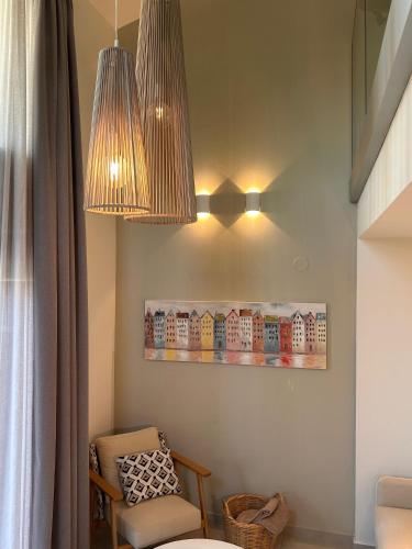 a room with a chair and a light fixture at Pelagus Luxury Villas in Polykhrono