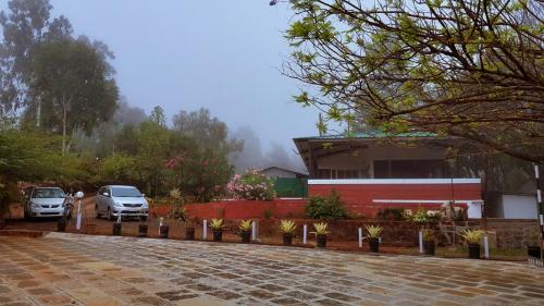 a parking lot with cars parked in front of a building at Shalgar Villa The Homestay in Satara