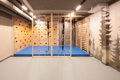 a gym with a bouldering wall and a climbing wall at Neueröffnung ELVA PREMIUM APARTMENT HOTEL inklusive Sommerpass STUBAI SUPER CARD in Neustift im Stubaital