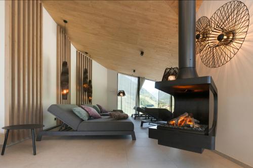 a living room with a couch and a fireplace at Neueröffnung ELVA PREMIUM APARTMENT HOTEL inklusive Sommerpass STUBAI SUPER CARD in Neustift im Stubaital