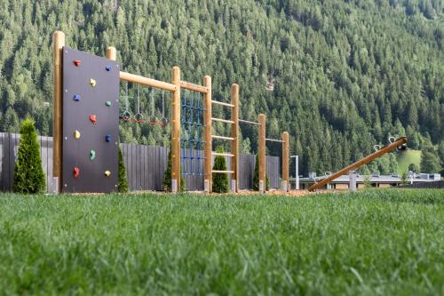a playground with a rock wall and a climbing wall at Neueröffnung ELVA PREMIUM APARTMENT HOTEL inklusive Sommerpass STUBAI SUPER CARD in Neustift im Stubaital