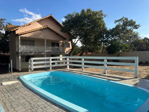 a swimming pool in front of a house at Pousada Cipó in Serra do Cipo