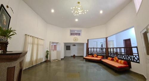 a living room with a couch and a balcony at Shalgar Villa The Homestay in Satara