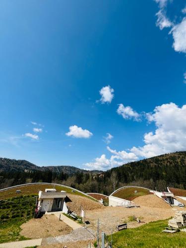 a view of a farm with a house on a hill at Apartments Relax Tále in Evergreen Resort in Tale