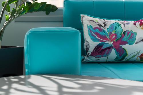 a blue couch with a pillow and a table at Sweet Pop in Fira