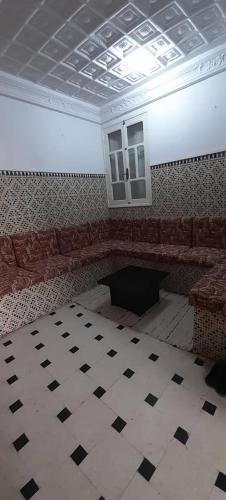 a room with a couch and a table and a ceiling at Bab bhar sousse in Sousse