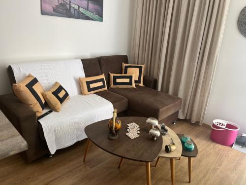 a living room with a couch and a table at Panos salt lake apartment in Aglantzia
