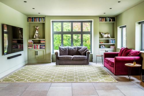 a living room with two chairs and a window at Kingsley House in Haslemere