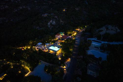 an aerial view of a house at night with lights at VILLA AMIRA Porto Cervo con vista Mozzafiato sul Mare,Piscina Privata,WELLNESS & SPA in Liscia di Vacca