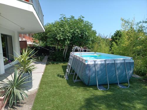 a swimming pool in a yard next to a house at Villa Black Sea in Balchik