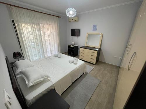 a bedroom with a bed and a dresser and a mirror at City Center Bazaar Apartment in Tirana