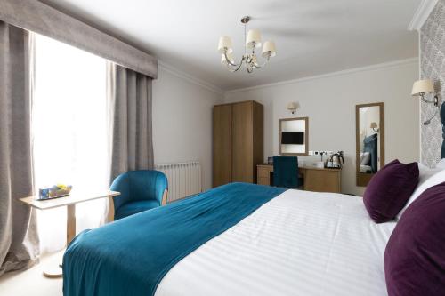 a hotel room with a large bed and a window at Best Western Hotel de Havelet in St Peter Port