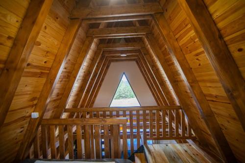 a view from the loft of a tree house with a window at Planinska kuća, Brvnara-Škodrić - Šljivovica, Zlatibor in Železnička Stanica Branešci