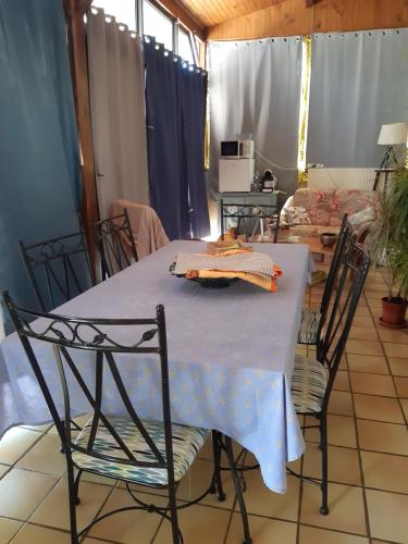 une table avec des chaises et un chiffon de table bleu dans l'établissement chez sylvie et jean-yves, à Chagny