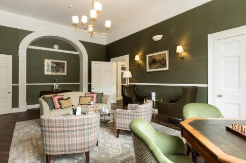 a living room with a couch and chairs and a table at Best Western Hotel de Havelet in St Peter Port
