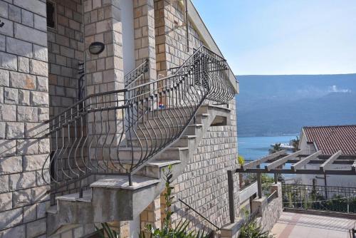 a spiral staircase on the side of a building at Falcone Apartments in Ðenovići